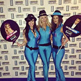 Three sexy brand ambassadors dressed in slinky blue outfits